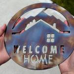 Besides the house keys, the nine new homeowners received burnished stainless steel &ldquo;Welcome Home&rdquo; plaques to hang by the front doors of their new residences. Asla/Kitsap News Group