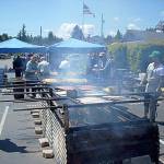 The Friends of Manchester Library will host its annual salmon bake and book sale on Father&rsquo;s Day, June 18 at the library&rsquo;s parking lot, 8067 E. Main St., in Manchester. As in past years, the Bow family will gather to build the alder fire and bake the salmon delicacy. Submitted photo.