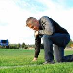 Joe Kennedy kneeling on the 50-yard line of a football field in prayer.                                Courtesy Liberty Institute