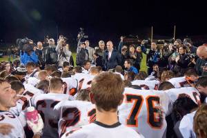 Dozens of Centralia High School football players surround Joe Kennedy, then-assistant football coach, for a prayer on the 50-yard line Oct. 16, 2015. Judge M. Smith, 9th Circuit Court of Appeals, brought up this photo when Kennedy&rsquo;s lawyer Rebekah Ricketts said they were fighting for Kennedy&rsquo;s right to &ldquo;pray quietly and alone.&rdquo;                                Kitsap News Group file photo
