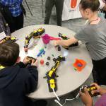 Children operate robotic arms at a 2016 Summer STEAM program.                                Photo courtesy of the U.S. Naval Undersea Museum