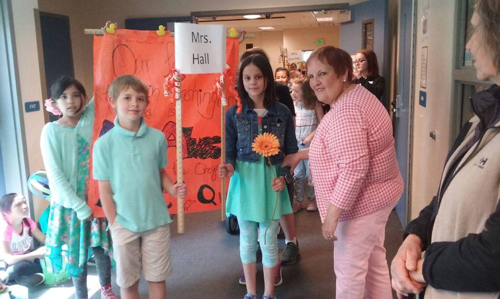 Principal Claudia Alves, right, sends students on their way through the parade. (Ian A. Snively/Kitsap News Group)