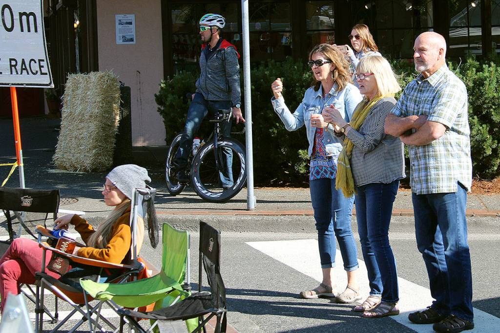 Spectators cheer the cyclists in the Poulsbo Twilight Criterium, June 3 in downtown Poulsbo. (Richard Walker/Kitsap News Group)