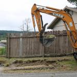 Poulsbo Public Works employee Richie Sardoff mans the shovel while Jerry Dakota on the backhoe begins the process of removing top soil, rocks and roots from the 4th Avenue footpath. Once the trail was leveled, a layer of gravel was put down. Terryl Asla/Kitsap News Group