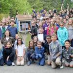 Fifth-graders at Vinland Elementary pose with their graduation gift to the school: a Little Free Library filled with donated books. Terryl Asla/Kitsap News Group