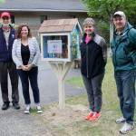 The grownups who helped. From left, Principal Charley McCabe,School Librarian Rebecca Ryan, PTSA project coordinator Kelli Ondusko and volunteer Gary Vance who built the Little Free Library.                                Terryl Asla/Kitsap News Group.
