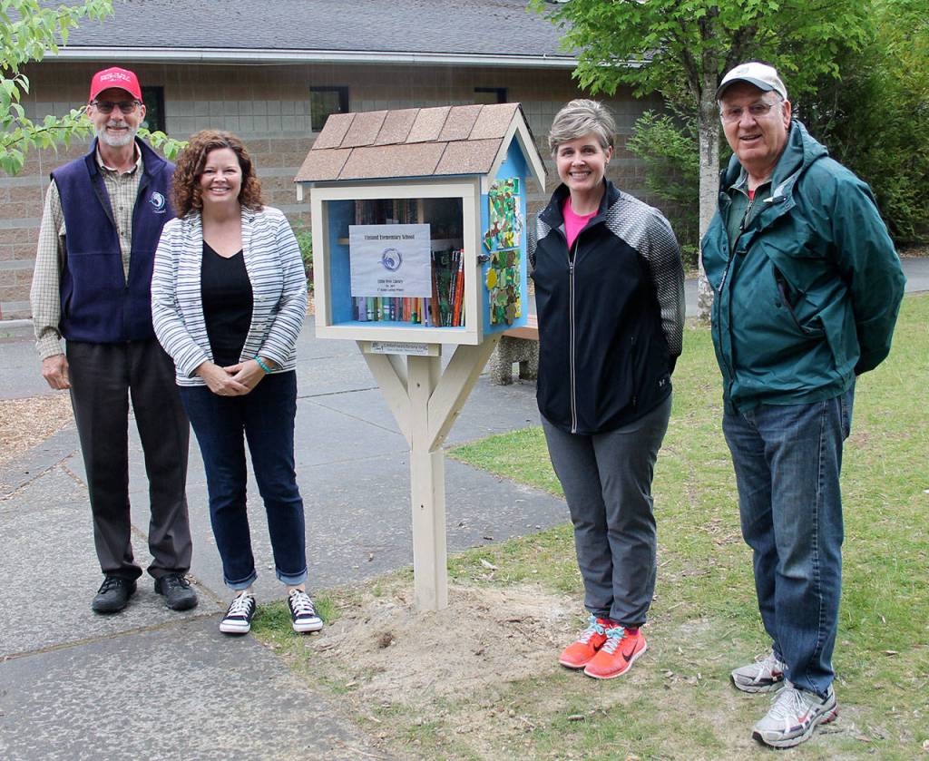 The grownups who helped. From left, Principal Charley McCabe,School Librarian Rebecca Ryan, PTSA project coordinator Kelli Ondusko and volunteer Gary Vance who built the Little Free Library.                                Terryl Asla/Kitsap News Group.