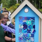 Every fifth grader painted at least one puzzle tile. The tiles were then glued to three sides of the Little Free Library.                                Terryl Asla/Kitsap News Group.