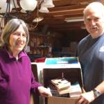 Alix Kosin and Howie O&rsquo;Brien sort more than 5,000 books in preparation for the big Greater Hansville Community Center book sale June 9-11.                                 Annette Wright / Contributed