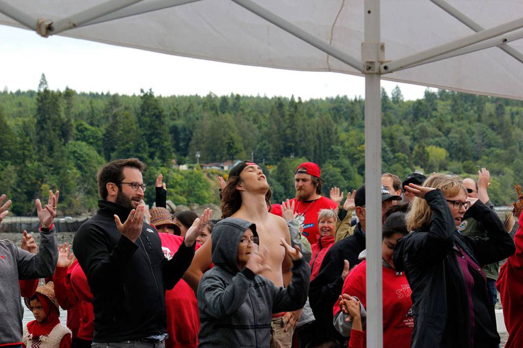 Hands and hearts are raised in gratitude June 8 at the celebration of the cleanup of the former mill site and nearshore, June 8.  Sophie Bonomi/Kitsap News Group