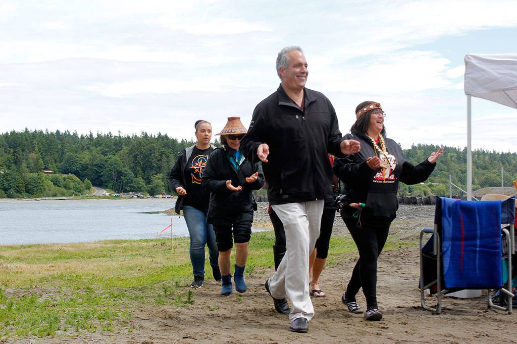 Olympic Property Group president Jon Rose joins Port Gamble S&rsquo;Klallam Tribe members in a dance on June 8 at the celebration of the cleanup of the former mill site and nearshore, at Port Gamble. (Sophie Bonomi/Kitsap News Group)