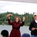 Ecology Director Maia Bellon raises her hands in thanks during a presentation of gifts at the celebration of the cleanup of the former mill site and nearshore, June 8 at Port Gamble. (Sophie Bonomi/Kitsap News Group)