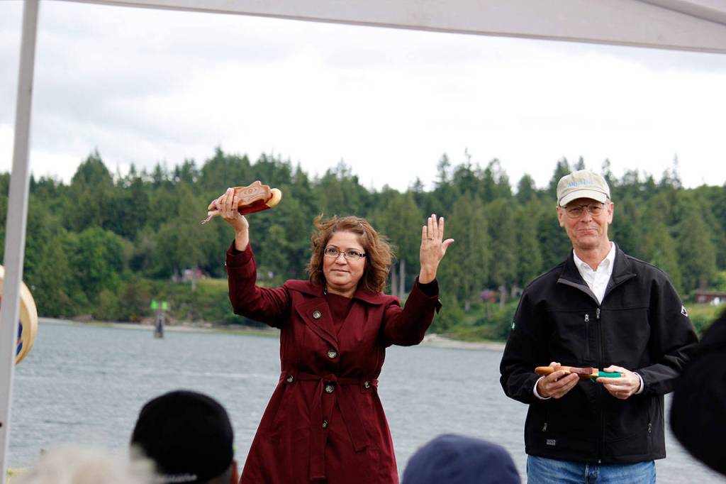 Ecology Director Maia Bellon raises her hands in thanks during a presentation of gifts at the celebration of the cleanup of the former mill site and nearshore, June 8 at Port Gamble. (Sophie Bonomi/Kitsap News Group)