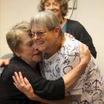At the June 14 reunion, Susan Willis, wearing glasses, hugs her good friend Lori Robinson while Sandy Mead looks on. Robinson and Mead helped save Willis&rsquo; life May 6 when she choked and stopped breathing. Terryl Asla/Kitsap News Group