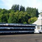 Five of the new main walkway units for the port&rsquo;s B dock are stacked in the port&rsquo;s parking lot in front of the lighthouse. There will be 10 walkway units in all, replacing the old, wooden docks. The new docks are recyclable and environmentally-friendly. (Terryl Asla/Kitsap News Group)