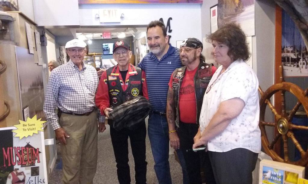 The Suquamish Tribe presents a model of a Coast Salish canoe to the Poulsbo Maritime Museum, July 14.From left, museum board president Tom Henderson, Rich Demain, Suquamish Tribe Chairman Leonard Forsman, Ray Holdroc of the Suquamish Warriors veterans group, and Poulsbo Mayor Becky Erickson.  Ian A. Snively / Kitsap News Group