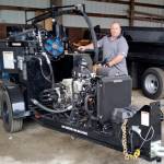 Mike Lund, Public Works superintendent, shows off the city&rsquo;s new crack sealer. Sealing cracks on city streets slows deterioration and prolongs the life of the pavement.                                Terryl Asla/Kitsap News Group