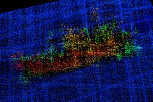 From above, the profile of the vessel is clearly visible, including the bulbous bow to the right, the forward house and mast, equipment (likely crab pots) stacked amidships, the deck crane aft, and the skeg and rudder. (NOAA)