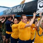 Sailors from Naval Base Kitsap carry a canoe to the lawn outside the House of Awakened Culture, July 20, during the 2017 Canoe Journey. Canoe families are traveling to We Wei Kai and Wei Wai Kum First Nations territory at Campbell River, B.C. Suquamish was an early stop for Puget Sound indigenous nations traveling in the annual gathering of Northwest canoe cultures. (Richard Walker/Kitsap News Group)