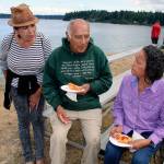 Suquamish Tribe culture-bearer Ed Carriere shares what the Canoe Journey means to indigenous peoples. &ldquo;When I was young, the canoes were gone,&rdquo; he said. &ldquo;In the 1920s, &rsquo;30s and &rsquo;40s, nobody traveled by canoe anymore.&rdquo; With him, from left, are Marylin Bard, daughter of Canoe Journey founder Emmett Oliver, of Kingston; and Georgia George, Suquamish. (Richard Walker/Kitsap News Group)