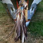 Eagle feathers are among those that adorn the bow of this Coast Salish canoe, on the lawn outside the House of Awakened Culture, July 20, during the 2017 Canoe Journey. Canoe families are traveling to We Wei Kai and Wei Wai Kum First Nations territory at Campbell River, B.C. (Richard Walker/Kitsap News Group)
