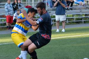 Kitsap SC&rsquo;s Jorge Ruiz battles with FC Mulhouse Portland defender Joel Bagby during their playoff game on July 15.