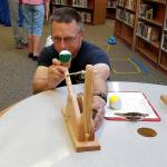 When Steve Mastel from PSNS wasn&rsquo;t helping youngsters shoot bean bags at a target with a rubber-band powered catapult, he wasn&rsquo;t above trying it himself.                                Terryl Asla/Kitsap News Group