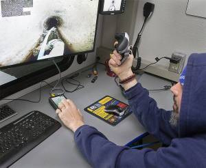 The crumbling sewer main was discovered as part of Poulsbo Public Works ongoing project to inspect and map the condition of all of the city&rsquo;s sewer and stormwater pipes. Here, a city employee drives a remote camera robot down a small residential sewer line.                                Terryl Asla/Kitsap News Group