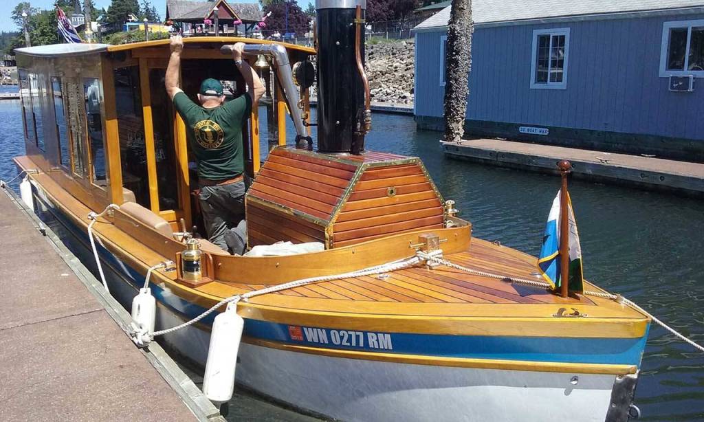 Dunlap climbs into his custom paddle boat, which took him 20 years to make.                                Ian Snively / Kitsap News Group