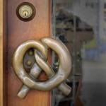 Marion Sluys wanted a bronze pretzel handle for the front door to the bakery. The plan was to have it cast in bronze which meant the foundry needed an original pretzel from which to make a mold. The first attempt to use a real pretzel failed, so the Sluys&rsquo; son, Dan, carved one out of wood.                                Terryl Asla/Kitsap News Group
