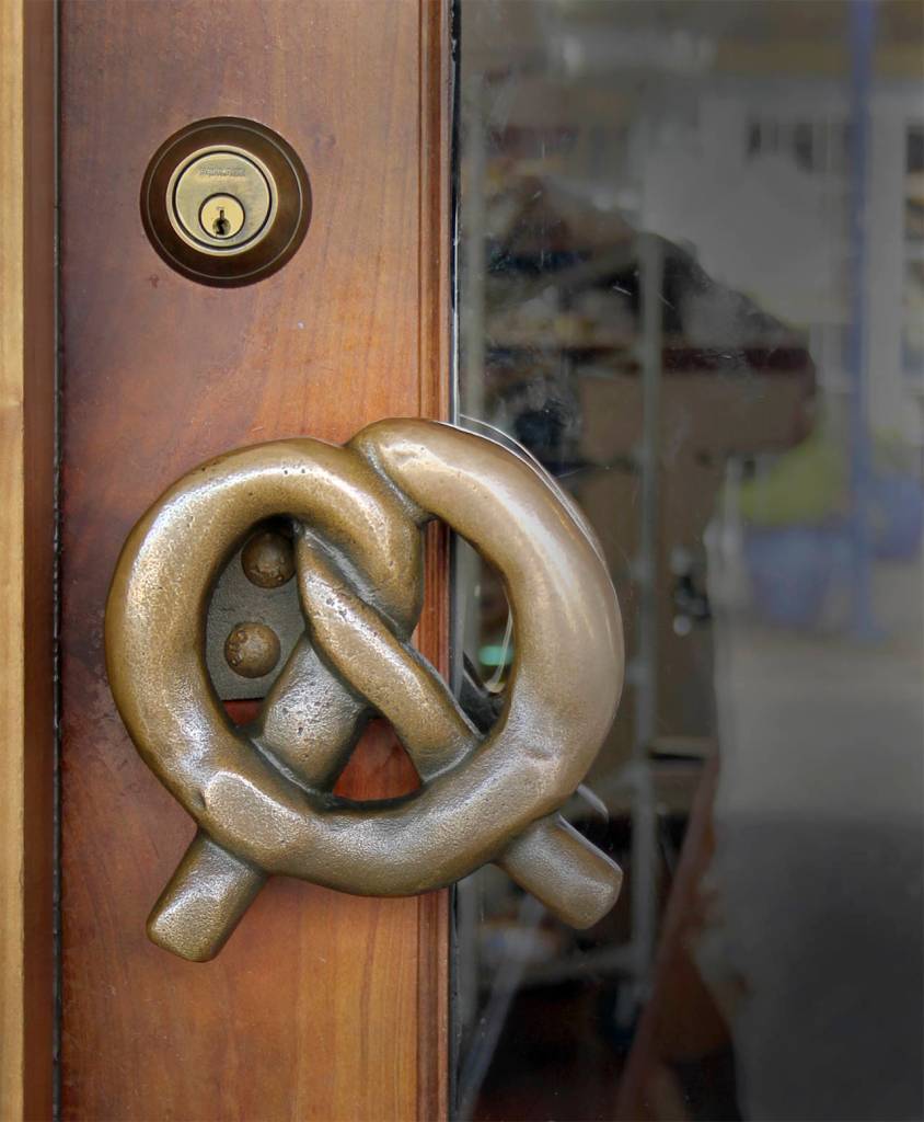 Marion Sluys wanted a bronze pretzel handle for the front door to the bakery. The plan was to have it cast in bronze which meant the foundry needed an original pretzel from which to make a mold. The first attempt to use a real pretzel failed, so the Sluys&rsquo; son, Dan, carved one out of wood.                                Terryl Asla/Kitsap News Group