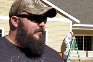 T/Sgt. Daniel Fye watches painters at work on his family&rsquo;s new mortgage-free, handicapped accessible home. On Aug. 26, community members are invited to come help landscape the property and lay turf. The key ceremony will be in late September. The home is being built by the nonprofit foundation, Homes for Our Troops. The home is being paid for with private cash donations and product donations from businesses like Sherwin-Williams.                                Terryl Asla/Kitsap News Group