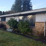 The two-bedroom, one-bath rambler on Mitchell Road in Port Orchard (shown here before the flip began) was in miserable shape &mdash; a tarp covered a leaky roof, the windows were defective and not energy efficient, and there were holes in the ceiling. Photo: Courtesy of Scott Studerus.