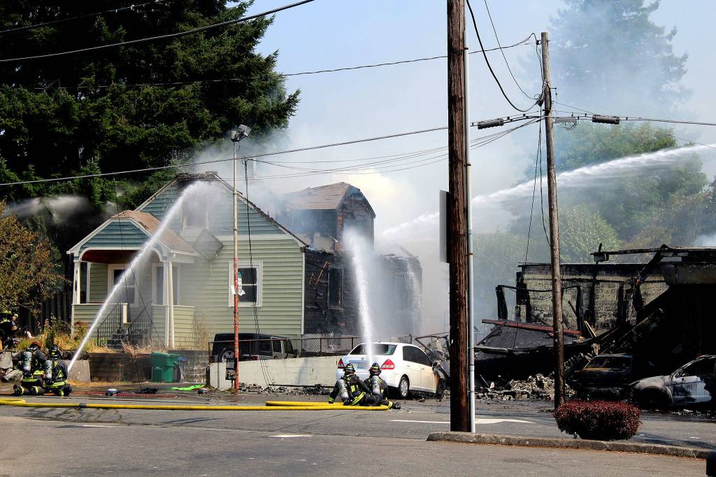 Crews from the Bremerton, South Kitsap, Central Kitsap and Navy Region Northwest fire departments work together to put out a two-alarm fire that started in Motor City Automotive, at the corner of North Callow Avenue and 11th Street, around 12:16 p.m. Aug. 3.                                Michelle Beahm / Kitsap News Group