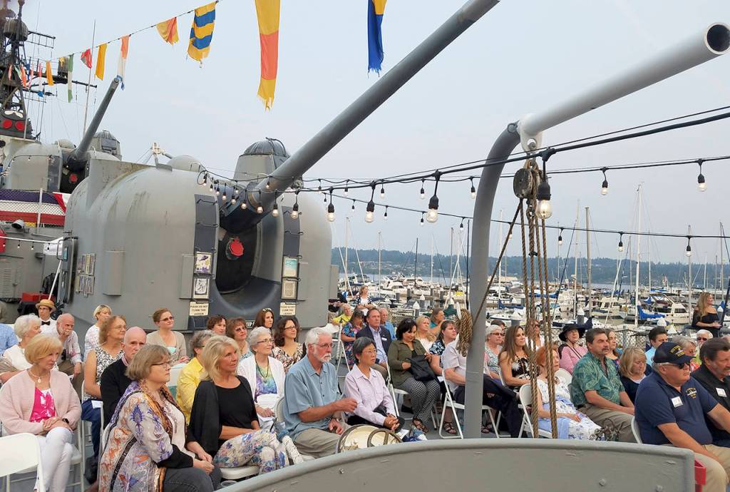 Guests gathered on the stern of the ship to listen to the evening&rsquo;s music, while enjoying complimentary hors d&rsquo;oeuvres, wine and beer and desserts.                                Terryl Asla/Kitsap News Group