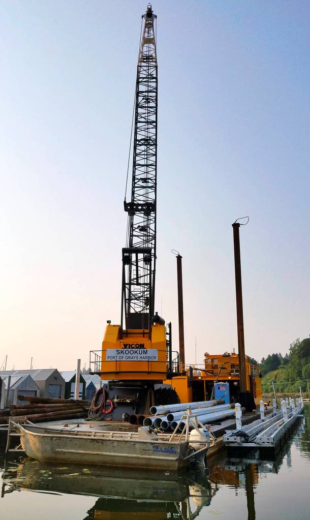 The Skookum, a pile-driving crane barge is owned by Quigg Brothers. The tall &ldquo;legs&rdquo; on the sides of the barge are lowered to the sea bed to help the barge stay in position and stabilize it when the crane is in action.