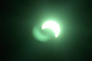 The solar eclipse, viewed through welder&rsquo;s glass, which gave the sight a green tint.                                Michelle Beahm / Kitsap News Group