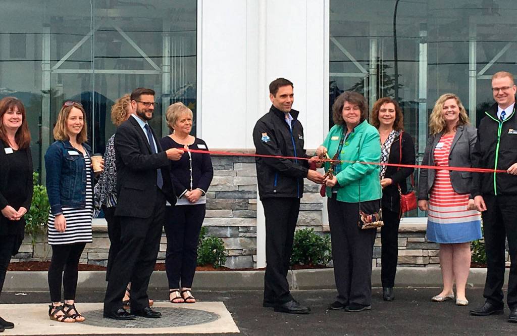 Center, Brown Bear owner Lance Odermat and Poulsbo Mayor Becky Erickson join members of the Poulsbo Chamber of Commerce in June at the grand opening of the car wash&rsquo;s Highway 305 location. (Bill McDonald/Kitsap News Group)