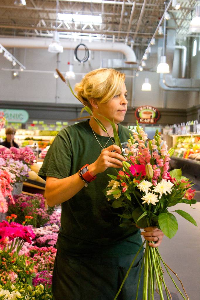 Three generations of Sally Priest&rsquo;s family have worked for Central Market. She is the store&rsquo;s floral manager of 12 years. Her son, Alex, is a courtesy clerk. Her parents, Steve and Sue, ran the pharmacy for a number of years. She described her experience with the company in one word: &ldquo;Fulfilling.&rdquo; (Sophie Bonomi / Kitsap News Group)