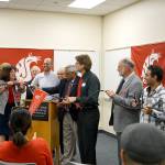 Representatives from Olympic College and Washington State University connect power cables to symbolize the opening of the new electrical engineering building, part of the Bremerton OC campus.                                Photo courtesy Olympic College
