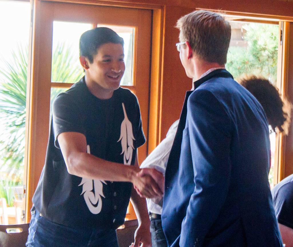From right, U.S. Rep. Derek Kilmer, D-Gig Harbor, meets a Millennial constituent Aug. 29 at Kiana Lodge. (Sophie Bonomi/Kitsap News Group)