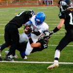 Senior running back SemaJ Cook breaks through the defense to give Bremerton a 13-0 lead in the first quarter. (Mark Krulish/Kitsap News Group)
