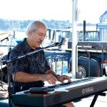 Steve Cossu, a local musician playing as part of a jazz trio, was the first musical act to perform for the crowd at the three-day Blackberry Festival on the Bremerton Boardwalk. (Mark Krulish/Kitsap News Group)