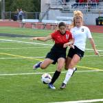 Central Kitsap midfielder Marielle Arnold (5) battles with Yelm sophomore Emily Schmidlkofer (11) for possession of the ball in the first half of the Cougars&rsquo; 2-0 victory. (Mark Krulish/Kitsap News Group).