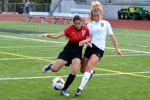 Central Kitsap midfielder Marielle Arnold (5) battles with Yelm sophomore Emily Schmidlkofer (11) for possession of the ball in the first half of the Cougars&rsquo; 2-0 victory. (Mark Krulish/Kitsap News Group).