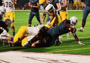 Senior running back Izaiah Davis breaks through the line on a two-point conversion during South Kitsap&rsquo;s 55-21 loss to Ferndale. (Mark Krulish/Kitsap News Group)