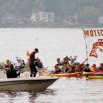 Protesters honk, chant and wave signs for the television camera boat.                                 Terryl Asla/Kitsap News Group