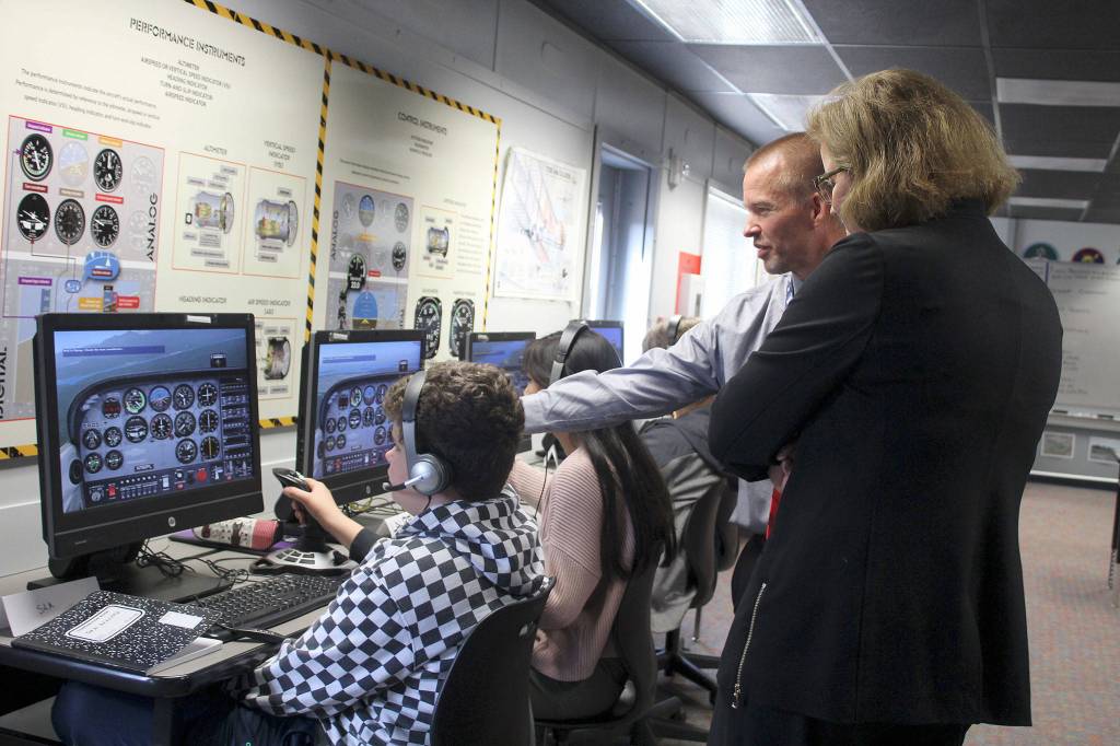 Sen. Christine Rolfes, D-23rd District, and Ridgetop Middle School Principal Rusty Willson talk to students in the aviation class.                                Michelle Beahm / Kitsap News Group