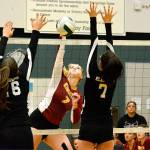 Kingston junior Ava McCabe (7) puts down one of her 14 kills as Klahowya&rsquo;s Chloe Settle (26) and Kindra Fuller (7) attempt to make the block. (Mark Krulish/Kitsap News Group)