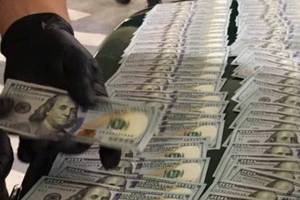 In a car in the Poulsbo Safeway parking garage early Sept. 24, officers found two stolen handguns, two stolen fire service portable radios, stolen fire department equipment, body armor, ammunition, two fake badges, more than 30 grams of heroin and methamphetamine, and more than $9,500 in cash. (Kitsap County Sheriff&rsquo;s Office)